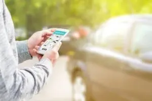 A person holding their phone after using a rideshare app to signify a case that a rideshare accident lawyer would review.