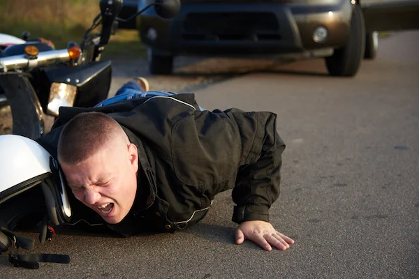 An injured motorcyclist on the road needs an Atlanta motorcycle accident lawyer.