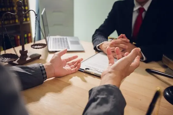 A bicycle accident lawyer speaking with a client on their bicycle accident case.