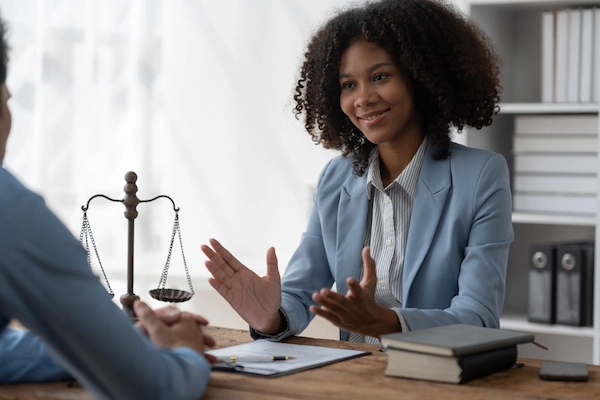 An Atlanta bicycle accident lawyer is speaking with a client at H Groves Law.