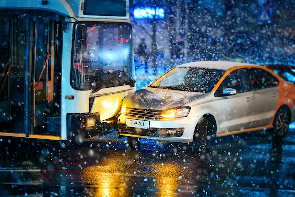 A bus accident lawyer is needed after a bus ran into a car on a snowy night.