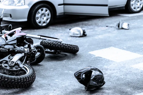 A motorcycle hit by a car symbolizes a motorcycle accident attorney.