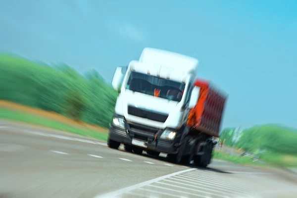 A truck moving fast represents a collision handled by a truck accident attorney.